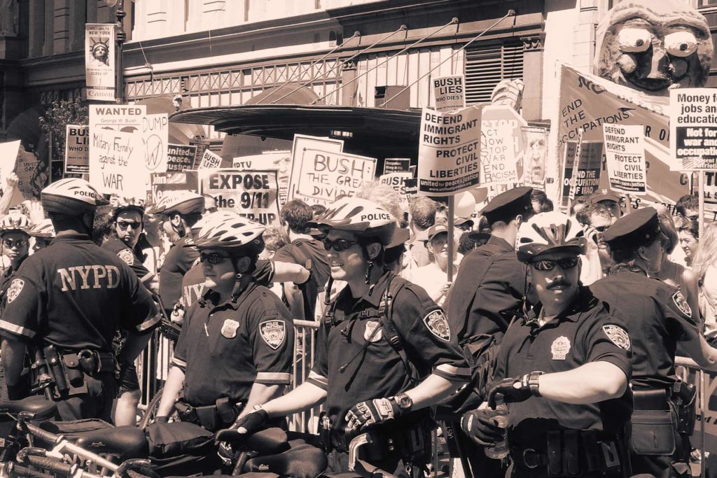 Police monitor protestors outside the 2004 Republican National Convention.