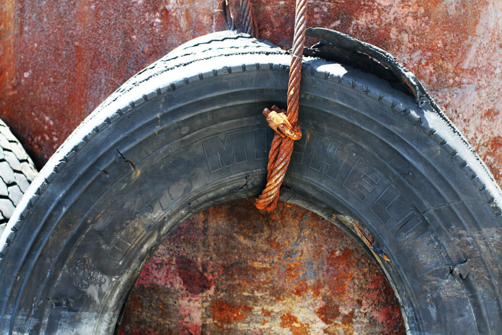 A tire hangs alongside the Gowanus Canal